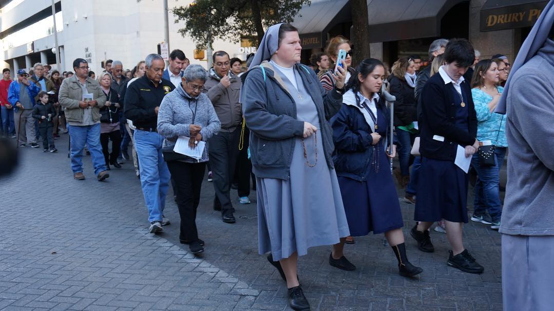 Catholics marching down a street