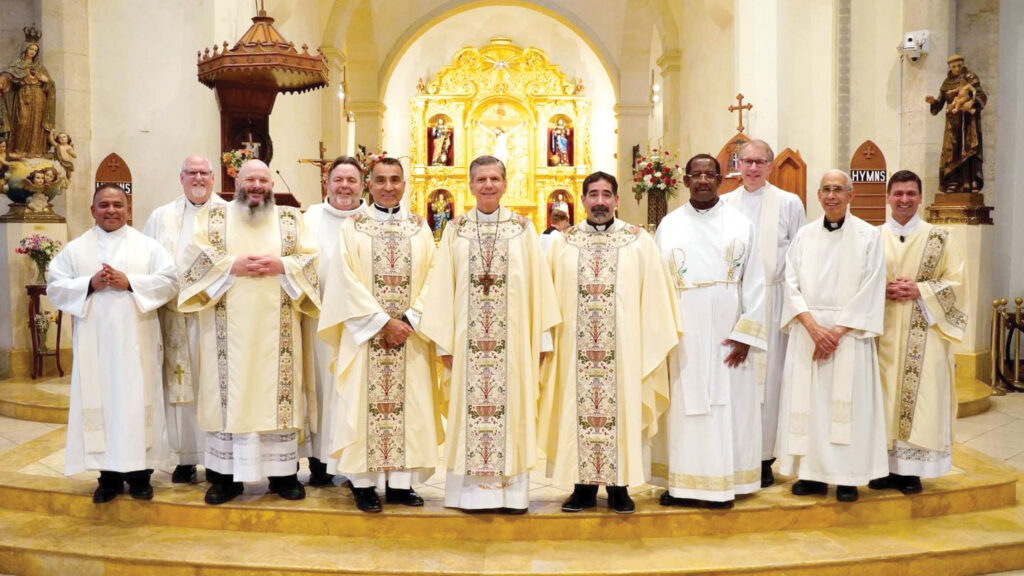 Vicars posing for picture in front of altar