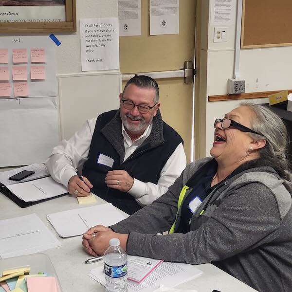 man and woman sitting and laughing