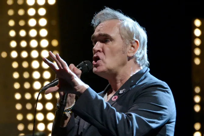 Morrissey singing into a microphone