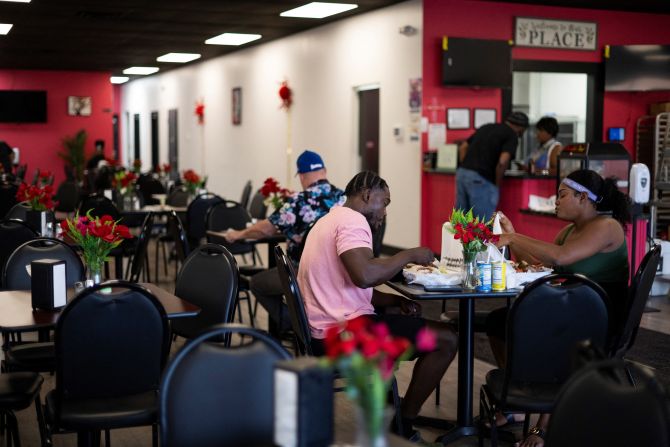 Haitians sit down to eat their meal at a Haitian restaurant in Springfield, Ohio