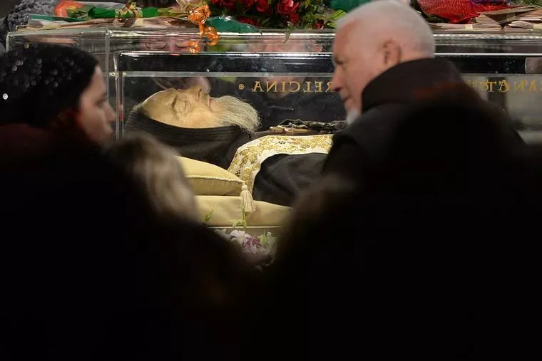 Worshippers gather to pray in front of the exhumed body of mystic-saint Padre Pio