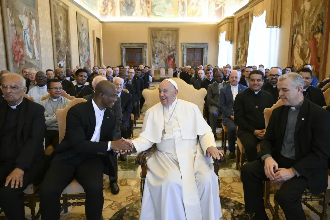 Pope Francis smiling and shaking hands