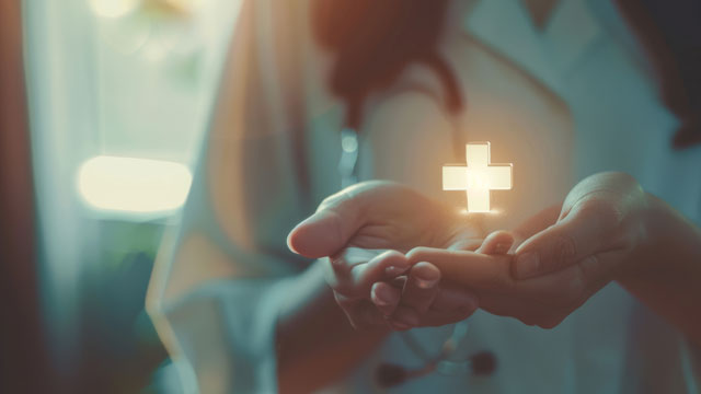 Doctor holding a glowing cross in hand