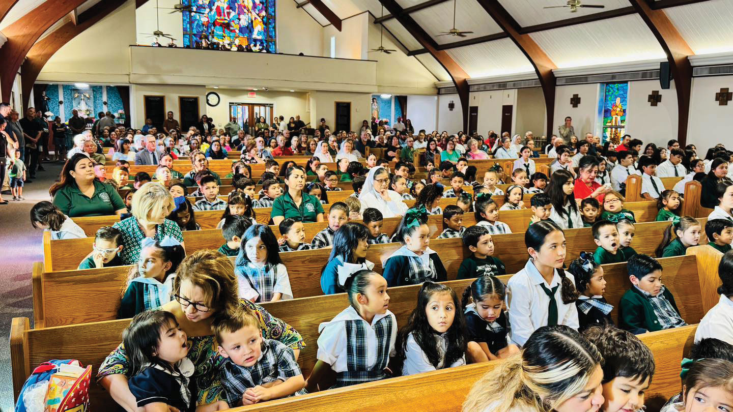 Students wearing Catholic school uniforms at Mass