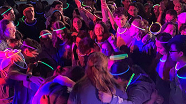 Group of catholic youth wearing glowing headbands