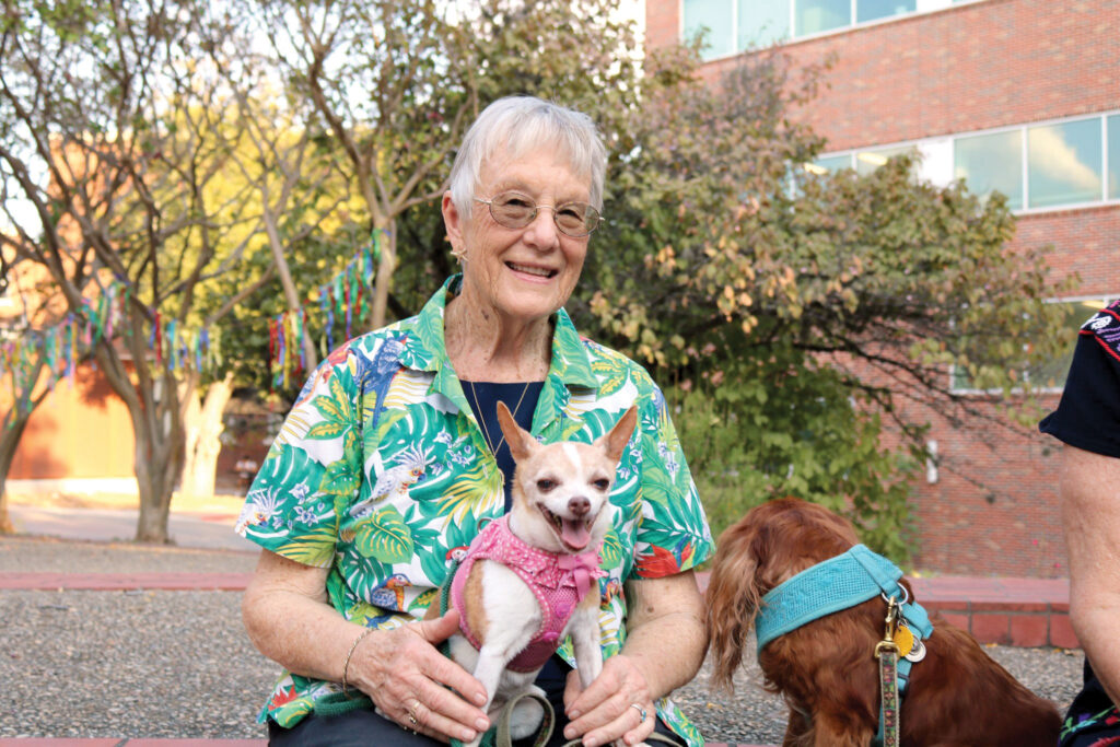 Woman with her dogs at a Blessing of the Pets celebration