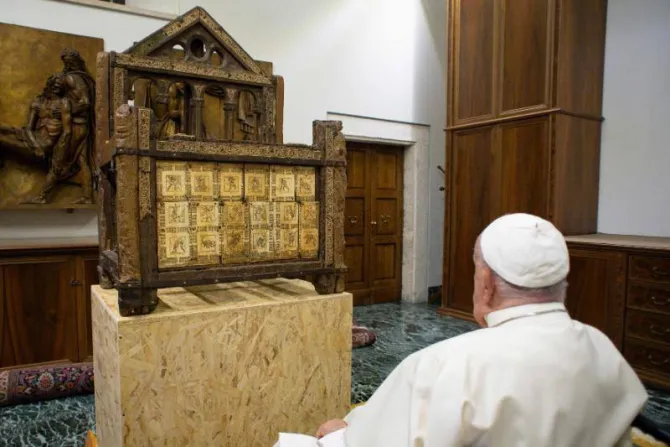 Pope Francis views a historic relic of the chair