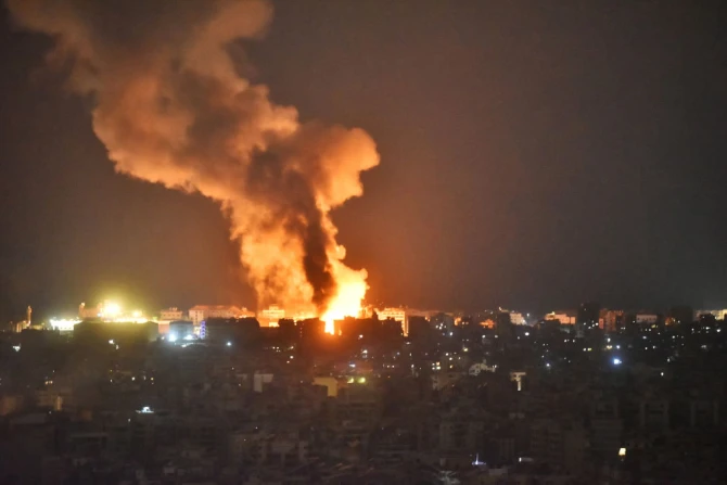 Fire and smoke rise at an area targeted by an Israeli airstrike on Beirut’s southern suburbs