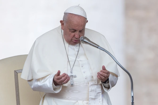 Pope Francis prays during his Wednesday general audience in St. Peter’s Square at the Vatican on Oct. 9