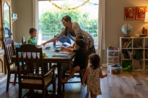 Maureen McKinley helps her children through some study exercises