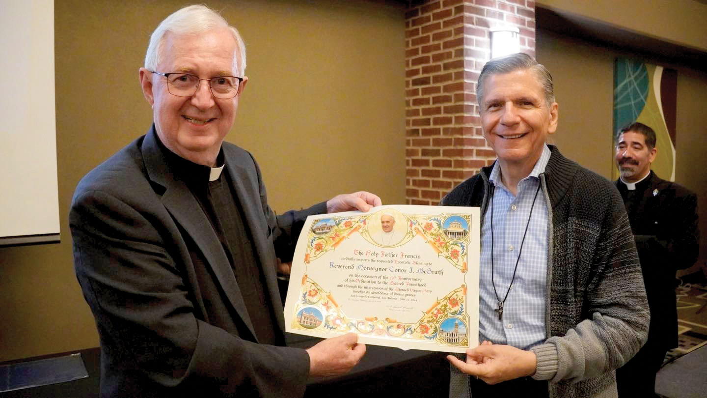 Archbishop Gustavo holding a papal blessing