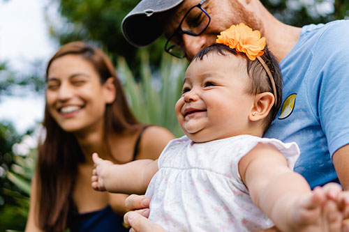 Young smiling parents with baby