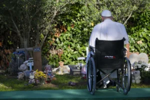 Pope Francis prays at the “Garden of Angels” section of the Laurentino Cemetery in Rome