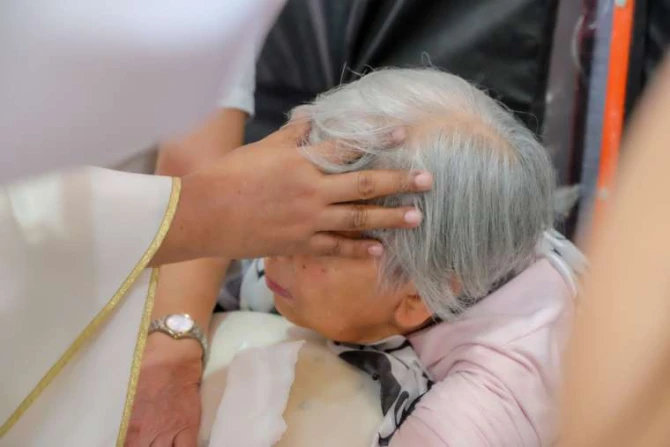 A priest administers the Anointing of the Sick