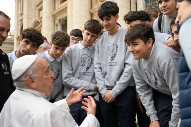 Pope Francis speaks with young men during a general audience